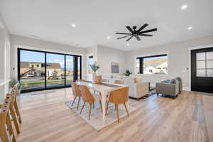 Dining area with light hardwood / wood-style flooring, a wealth of natural light, and ceiling fan