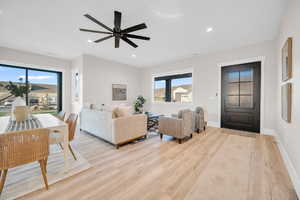 Living room featuring ceiling fan and light hardwood / wood-style floors