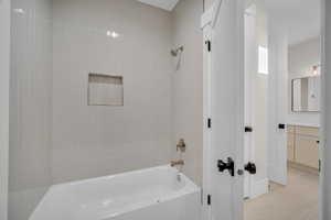 Bathroom with vanity and tiled shower / bath