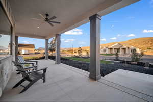 View of patio with ceiling fan and a mountain view