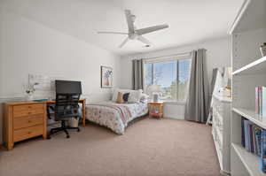 Carpeted bedroom with ceiling fan