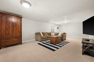 Living room featuring light colored carpet