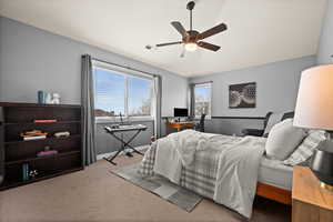 Bedroom featuring lofted ceiling, carpet flooring, and ceiling fan