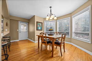 Dining area featuring a chandelier and light wood-type flooring