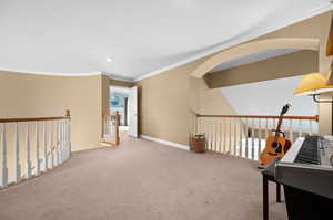 Hallway featuring ornamental molding and carpet floors