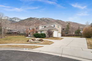 View of front facade with a mountain view and a front lawn