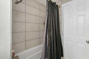 Bathroom featuring shower / bath combo with shower curtain