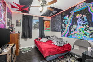 Bedroom featuring dark wood-type flooring and ceiling fan