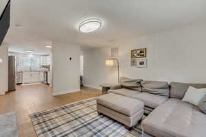 Living room featuring sink and light hardwood / wood-style floors