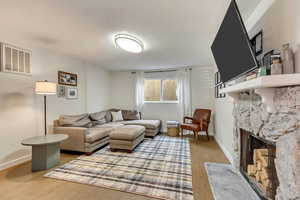 Living room with wood-type flooring and a fireplace