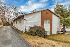 View of side of property with a yard