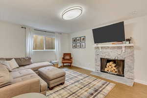 Living room with hardwood / wood-style flooring and a fireplace