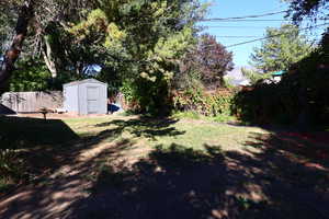 View of yard featuring a storage unit