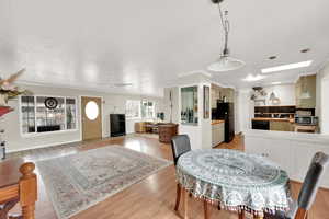 Dining area featuring ceiling fan and light wood-type flooring