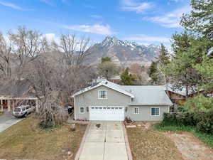 View of front of home with a garage and a mountain view