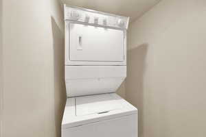 Washroom with stacked washer and clothes dryer