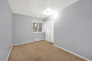 Empty room featuring carpet floors