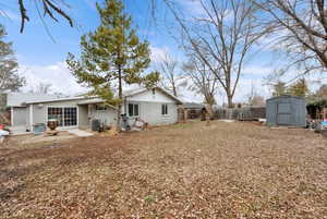 View of yard featuring central AC unit and a shed