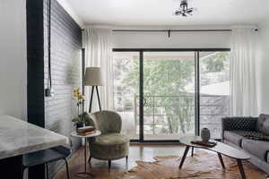 Living area with ornamental molding, a chandelier, and concrete flooring