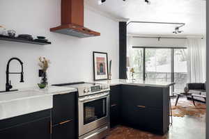 Kitchen featuring concrete floors, a sink, exhaust hood, stainless steel range with electric cooktop, and ornamental molding