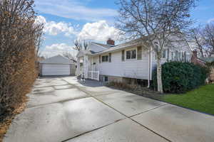 View of front of property featuring a garage and additional parking.