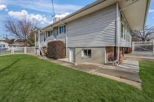 View of home's exterior with a lawn.