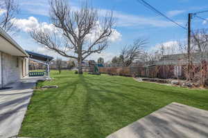 View of yard featuring a patio and a pond.