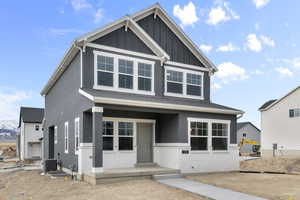 View of front of property with central air condition unit and a porch