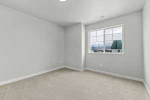 Empty room with light colored carpet