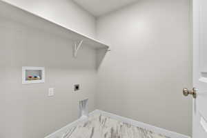 Washroom featuring hookup for a washing machine and electric dryer hookup