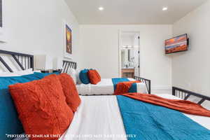 Bedroom featuring ensuite bath and carpet floors