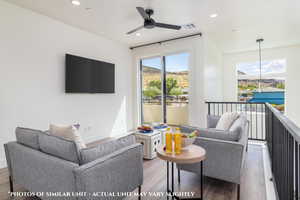 Living room with ceiling fan and light hardwood / wood-style flooring