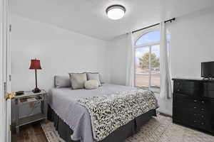 Bedroom featuring light hardwood / wood-style floors and a textured ceiling