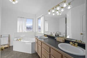 Bathroom with vanity, a bath, and toilet