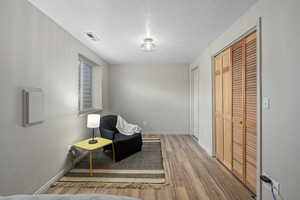 Sitting room featuring hardwood / wood-style flooring and a textured ceiling