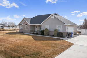 View of front of home with a garage and a front yard