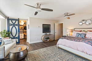 Bedroom featuring ceiling fan, dark wood-type flooring, a textured ceiling, and a spacious closet