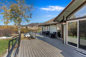 Wooden deck featuring a mountain view