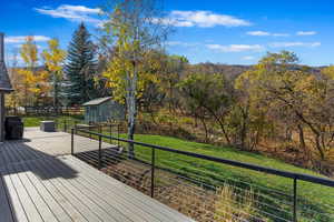 Wooden deck with grilling area and a lawn