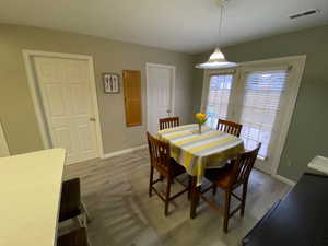 Dining area with light wood-type flooring