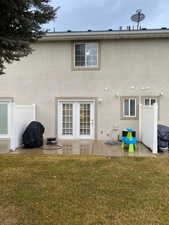 Back of house with a yard, central AC, and a patio area