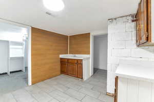 Kitchen featuring wooden walls