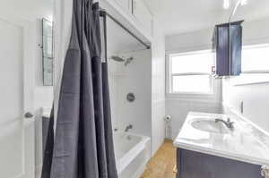 Bathroom featuring vanity and shower / bath combo with shower curtain