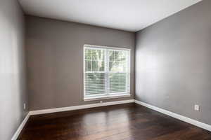 Spare room featuring dark hardwood / wood-style flooring