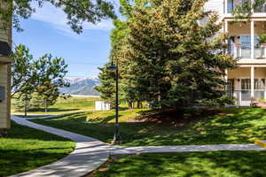 View of home's community featuring a mountain view and a yard