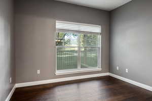 Spare room featuring dark hardwood / wood-style flooring