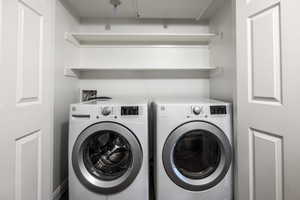 Washroom with washing machine and clothes dryer