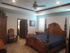 Bedroom featuring crown molding, light carpet, and ceiling fan