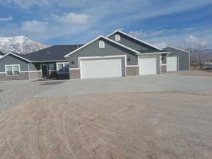 View of front facade with a mountain view and a garage