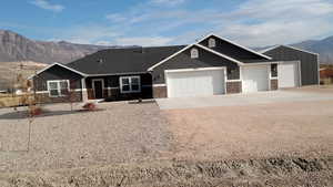 View of front facade with a mountain view and a garage